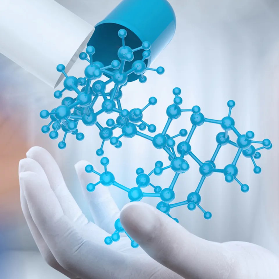 Molecule rising from a medicine capsule over a gloved hand